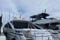 2015 Pershing 70 yacht docked at marina under cloudy sky.