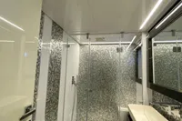 Luxurious bathroom in a 2015 Pershing 70 yacht, featuring modern fixtures and elegant design.