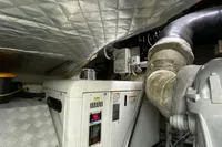 Engine room of a 2015 Pershing 70 yacht, featuring machinery and insulated ceiling.