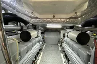 Engine room of a 2015 Pershing 70 yacht, featuring dual engines and metallic finishes.