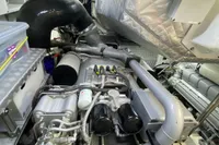 Engine room of a 2015 Pershing 70 yacht, showcasing complex machinery and components.