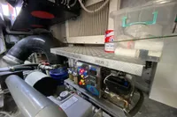 Engine room of a 2015 Pershing 70 yacht with equipment and maintenance items.