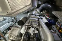 Engine room of a 2015 Pershing 70 yacht, showcasing complex machinery and components.