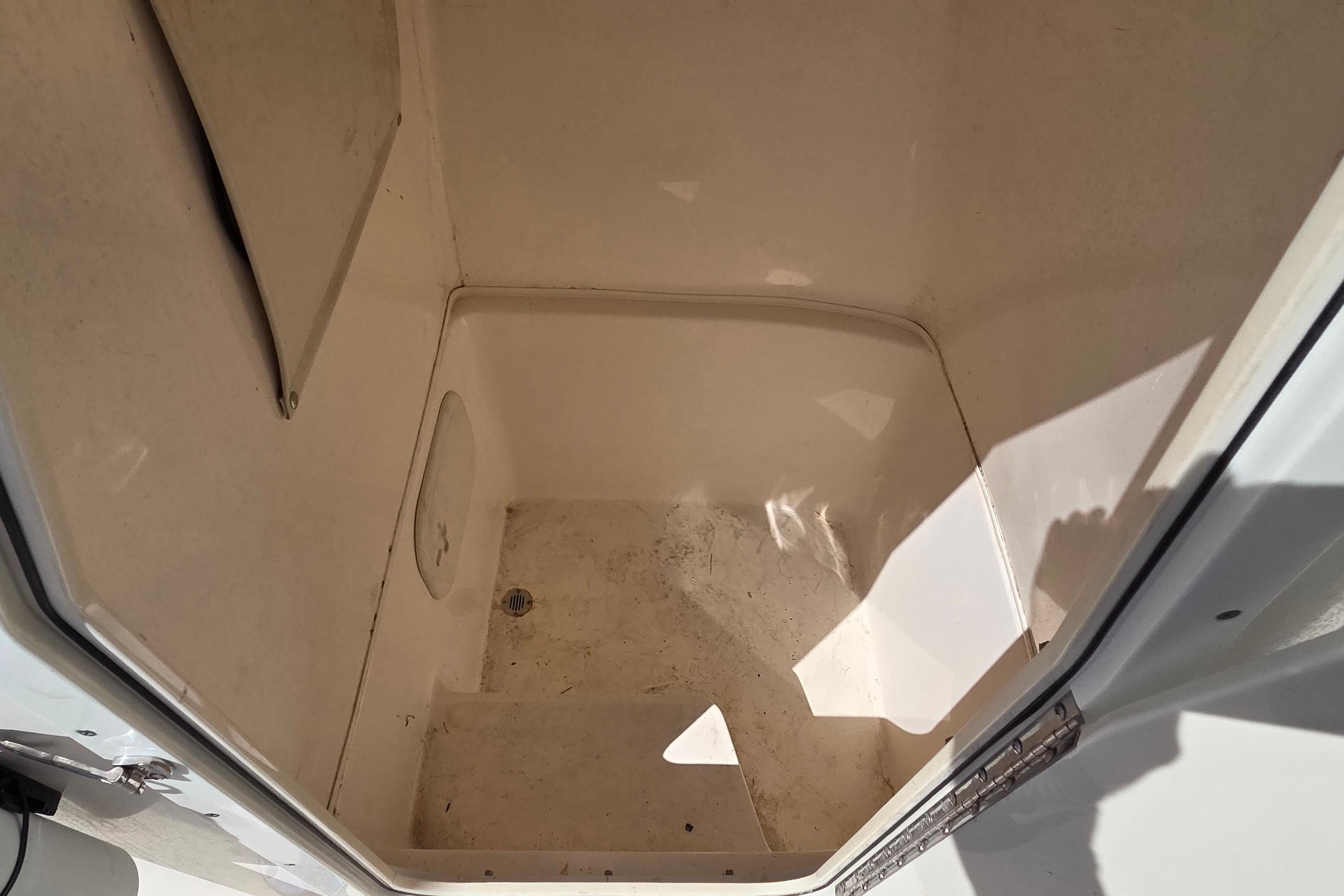 2020 Cobia 237 Center Console storage compartment interior, clean and spacious design.