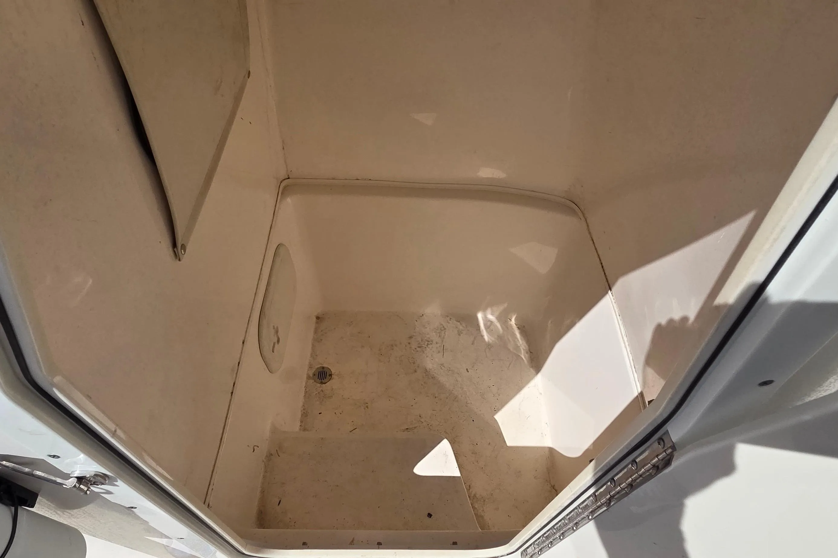 2020 Cobia 237 Center Console storage compartment interior, clean and spacious design.