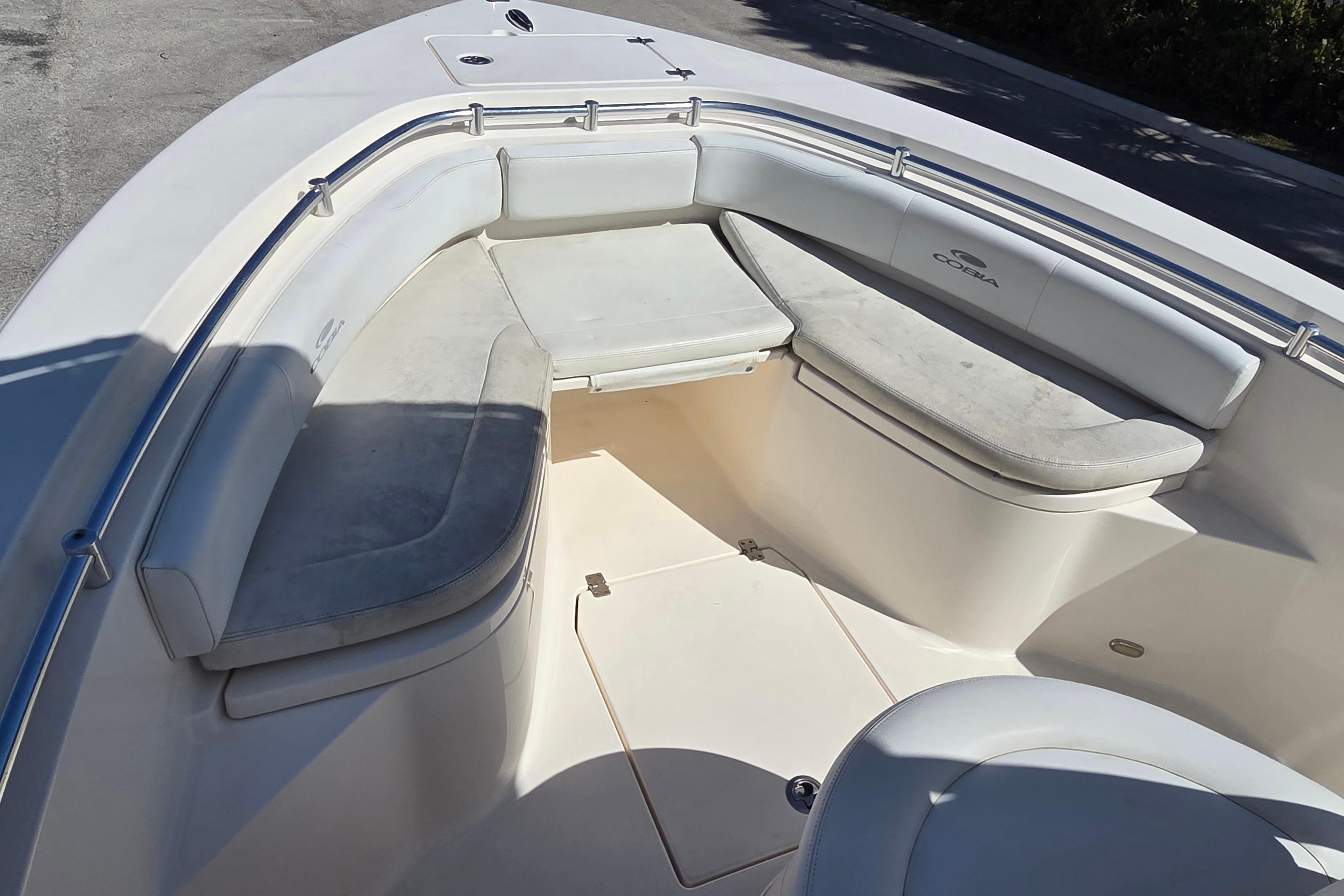 2020 Cobia 237 Center Console boat with spacious seating area and cushioned benches.