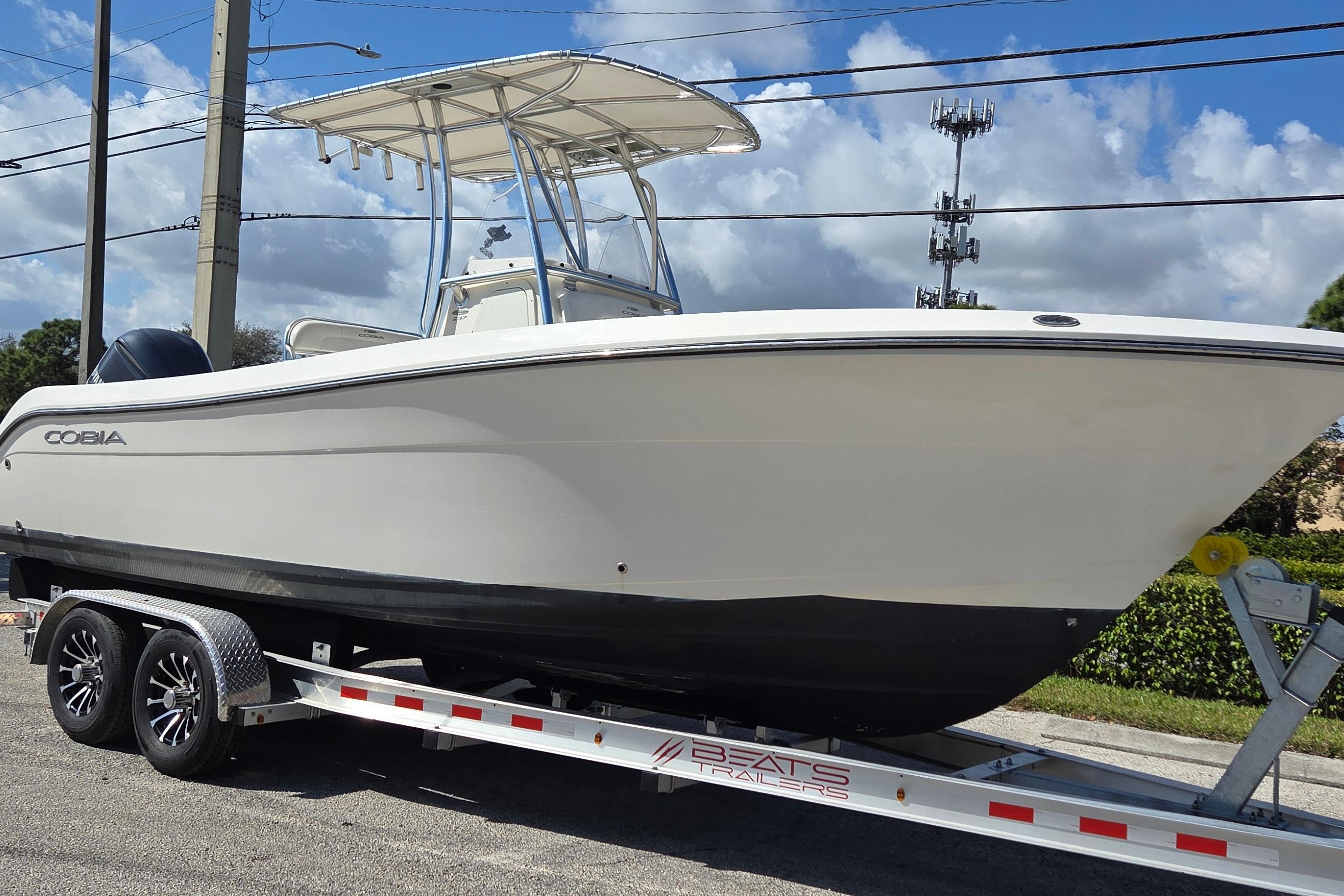 2020 Cobia 237 Center Console boat on trailer under blue sky.
