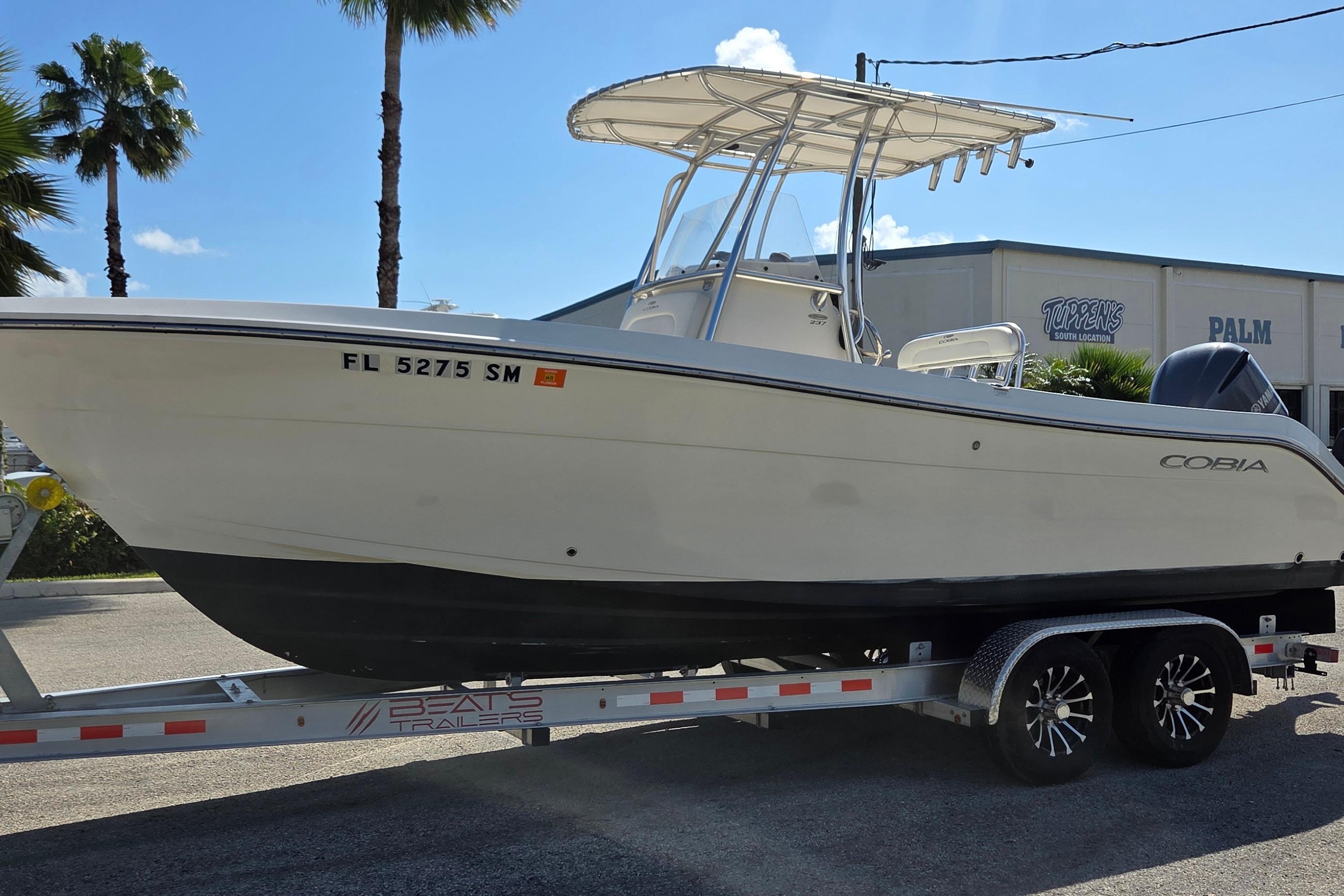 2020 Cobia 237 Center Console boat on trailer, parked outdoors under clear sky.