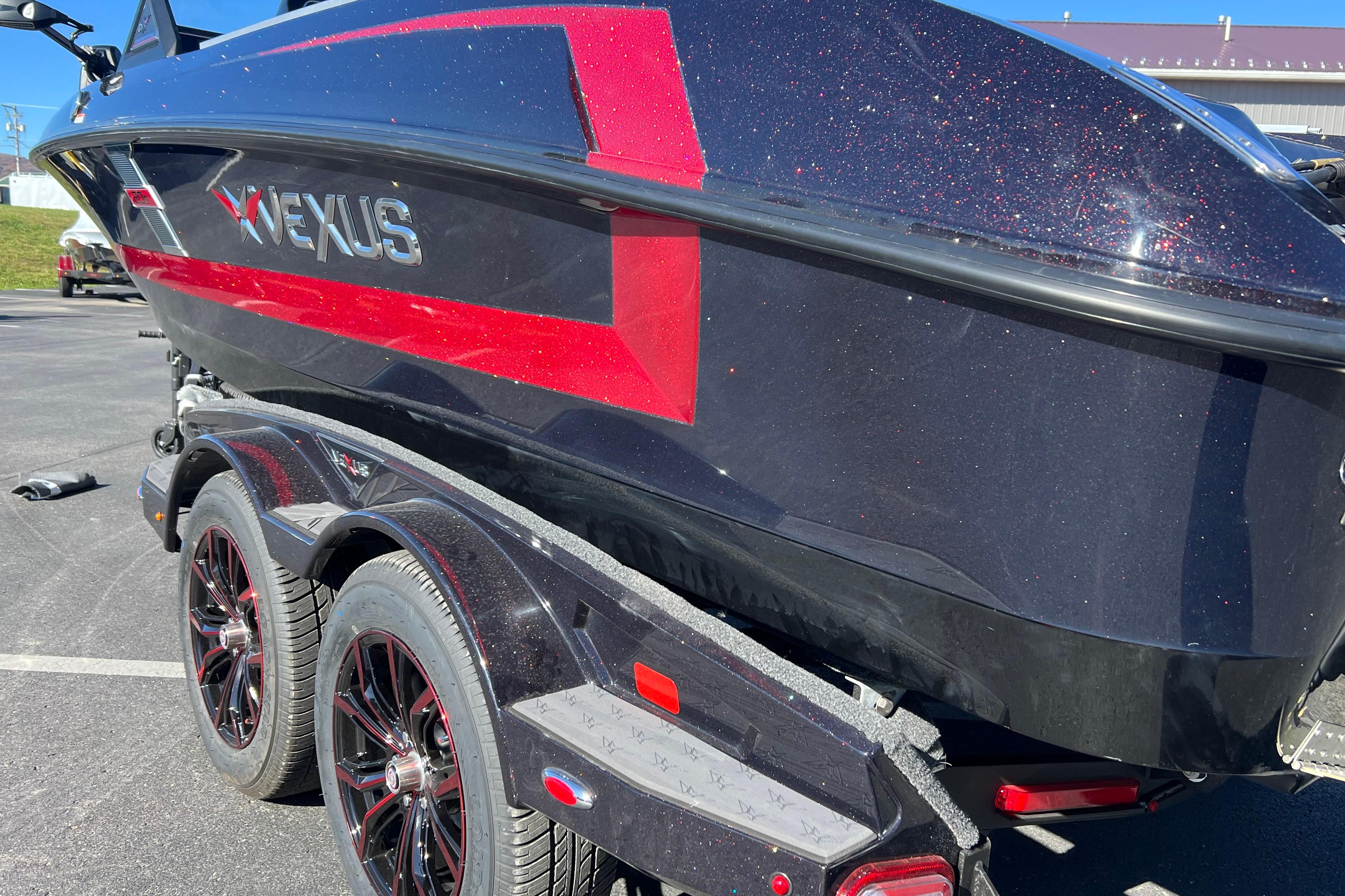2026 Vexus DVX20S boat with sleek black and red design on a trailer.