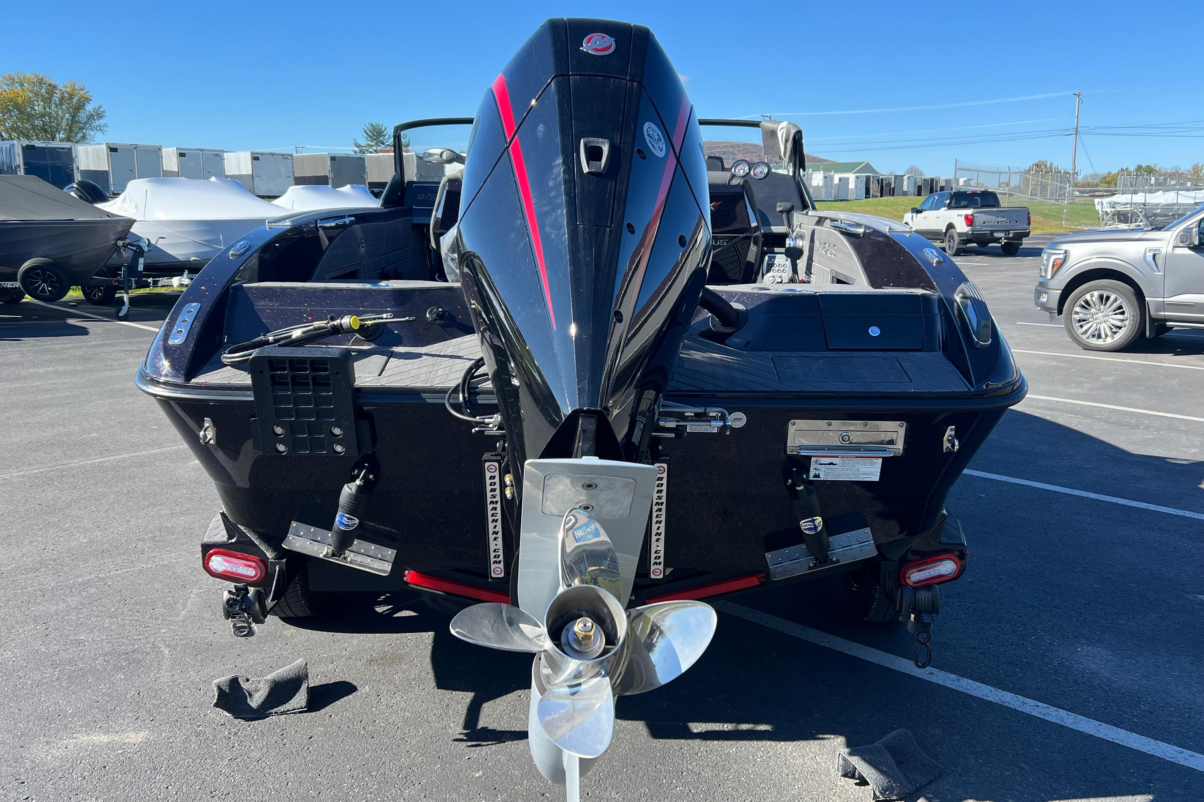 2026 Vexus DVX20S boat with powerful outboard motor in a parking lot.