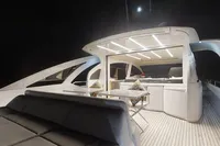 Luxurious 2015 Pershing 70 yacht deck at night, featuring modern seating and lighting.