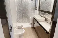 Luxurious bathroom in a 2015 Pershing 70 yacht with modern fixtures and sleek design.