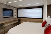 Luxurious bedroom interior of 2015 Pershing 70 yacht with modern design and red accents.