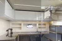 Modern kitchen interior on a 2015 Pershing 70 yacht, featuring sleek design and ample natural light.