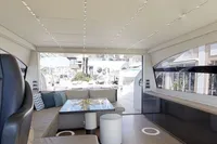 Luxurious interior of a 2015 Pershing 70 yacht with modern seating and elegant design.
