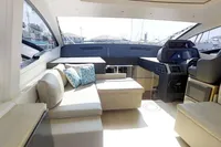 Luxurious interior of a 2015 Pershing 70 yacht with modern seating and helm.
