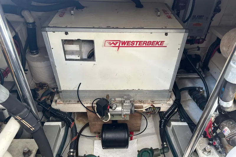 Pearl Yacht Photos Pics Engine room of a 1999 Eastbay 38 featuring a Westerbeke generator.