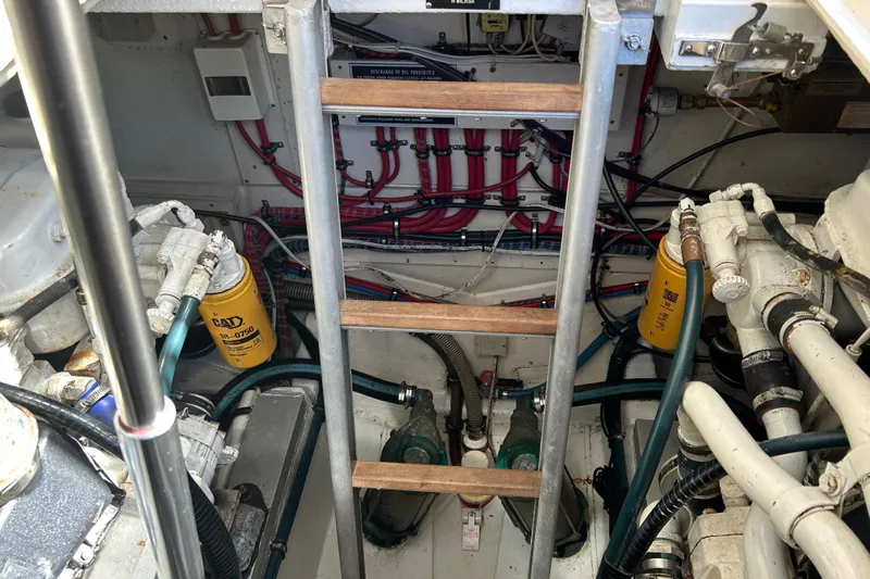 Pearl Yacht Photos Pics Engine room of a 1999 Eastbay 38 boat with visible machinery and wiring.