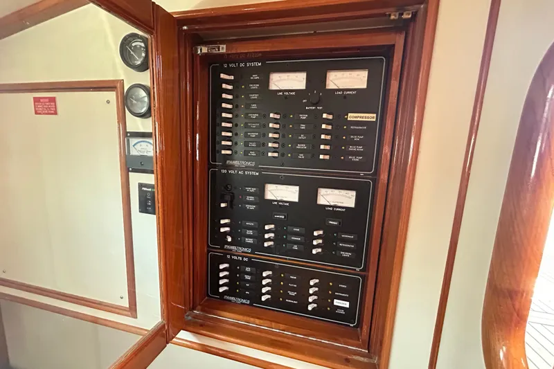 Pearl Yacht Photos Pics Electrical panel on a 1999 Eastbay 38 yacht, featuring AC and DC systems.