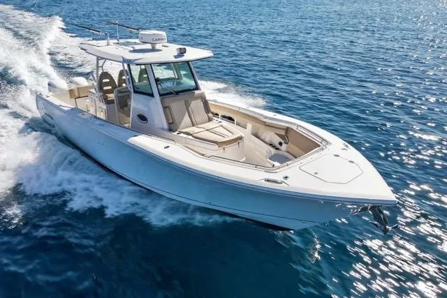 Odd Job Yacht Photos Pics 2019 Sailfish 360 CC boat cruising on open blue water.