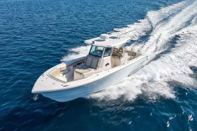 Odd Job Yacht Photos Pics 2019 Sailfish 360 CC boat cruising on open blue water.