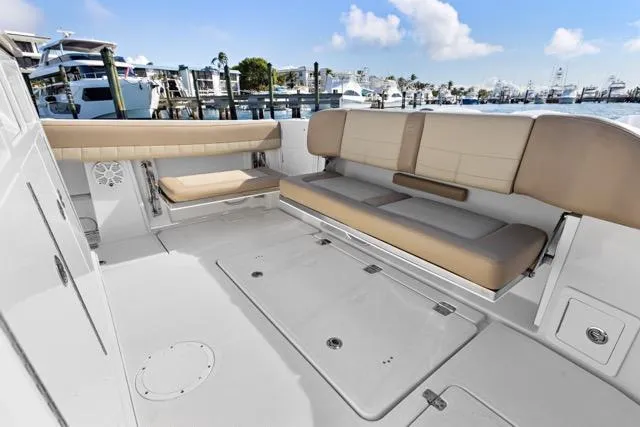 Odd Job Yacht Photos Pics 2019 Sailfish 360 CC boat interior with beige seating, docked at marina.
