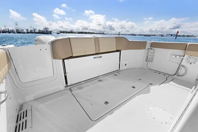 Odd Job Yacht Photos Pics 2019 Sailfish 360 CC boat deck with seating, overlooking a scenic waterfront.