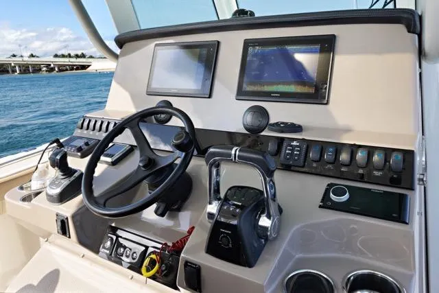 Odd Job Yacht Photos Pics 2019 Sailfish 360 CC boat dashboard with steering wheel, dual screens, and control panel.