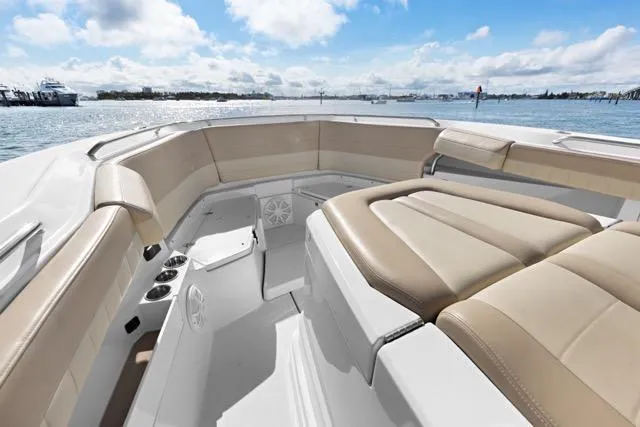 Odd Job Yacht Photos Pics 2019 Sailfish 360 CC boat interior with beige seating, ocean view, and clear sky.