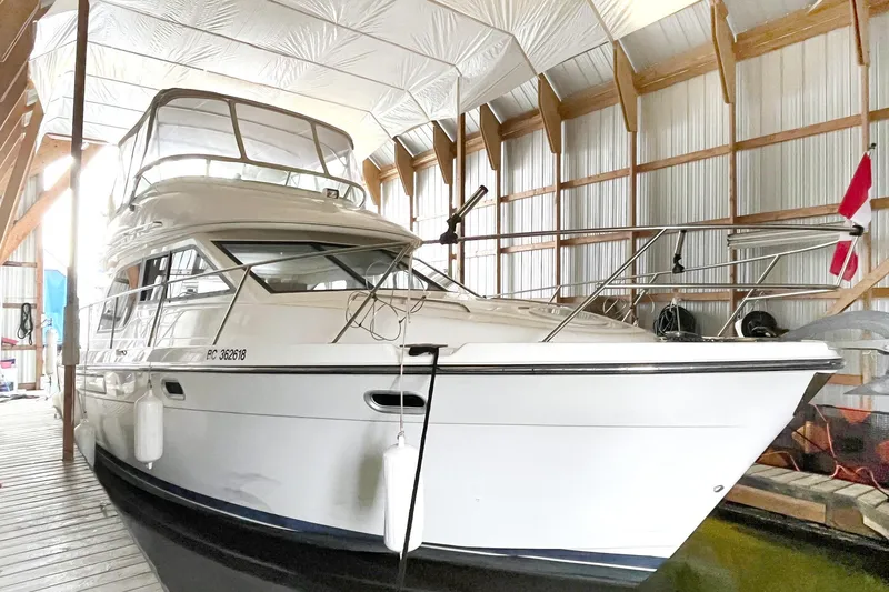 Lucky Stars Yacht Photos Pics 2002 Bayliner 3788 Convertible Sedan docked in a covered marina.