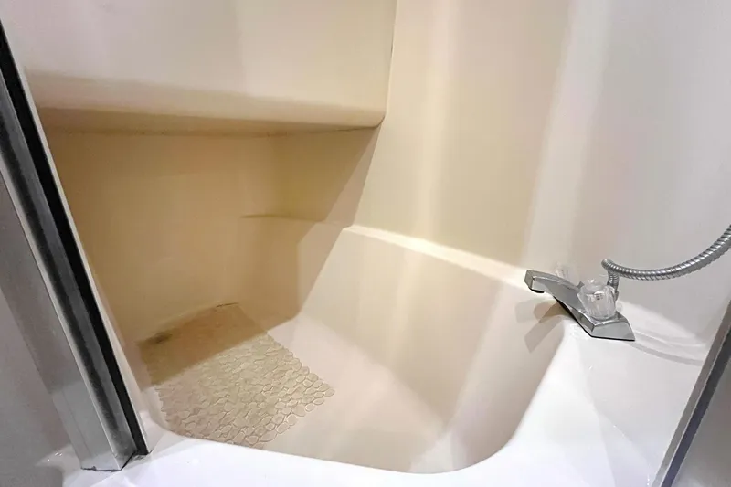 Lucky Stars Yacht Photos Pics Shower area in 2002 Bayliner 3788 Convertible Sedan boat, featuring a compact design.