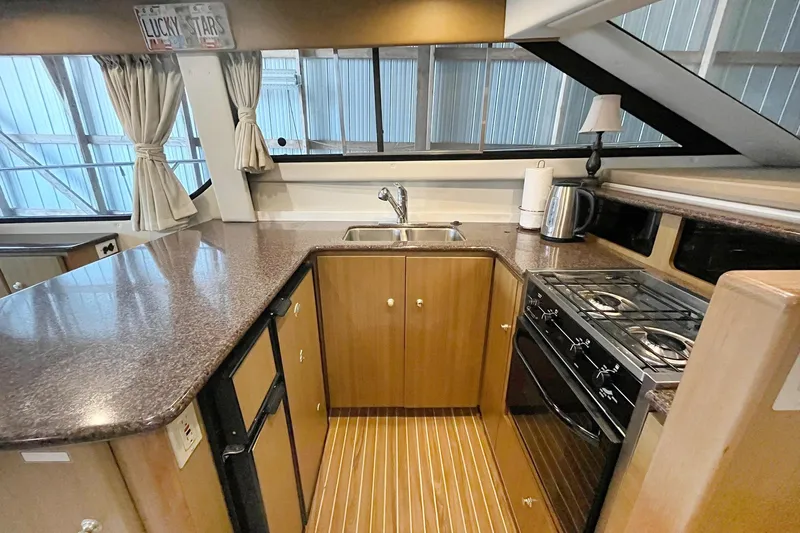 Lucky Stars Yacht Photos Pics Interior of 2002 Bayliner 3788 Convertible Sedan yacht kitchen with modern amenities.