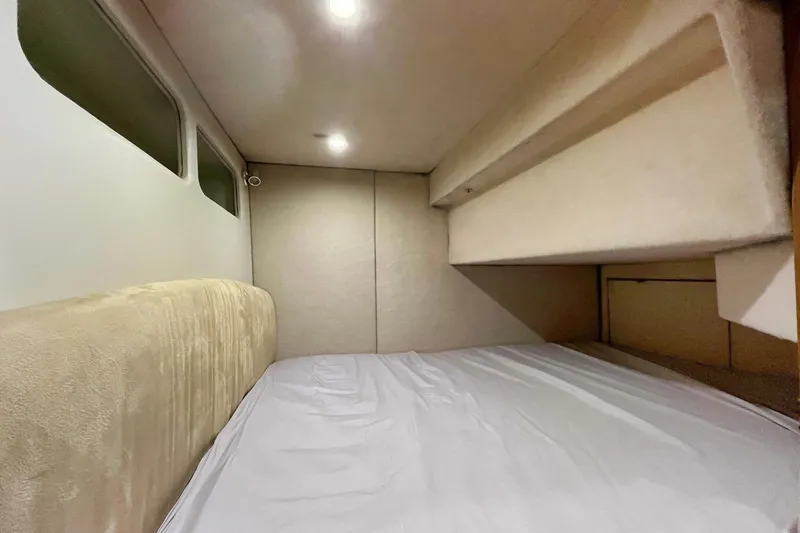 Lucky Stars Yacht Photos Pics Interior cabin of 2002 Bayliner 3788 Convertible Sedan with cozy bed and soft lighting.