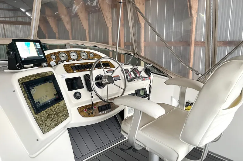Lucky Stars Yacht Photos Pics 2002 Bayliner 3788 Convertible Sedan helm with navigation screens and controls.