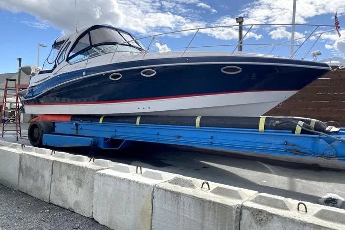  Yacht Photos Pics 2014 Four Winns V375 boat on trailer, blue and white design, docked outdoors.
