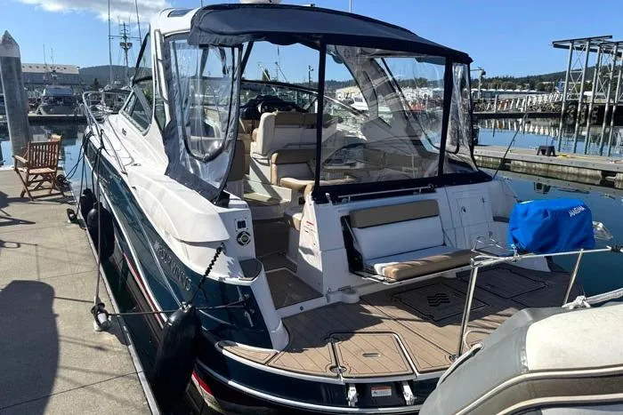  Yacht Photos Pics 2014 Four Winns V375 boat docked at marina, featuring spacious seating and clear canopy.