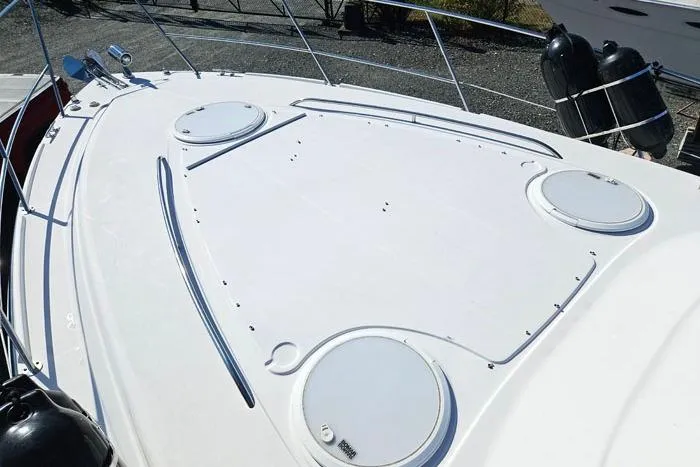  Yacht Photos Pics 2014 Four Winns V375 boat deck with hatches and railing, docked outdoors.