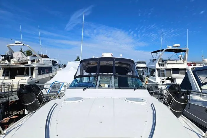  Yacht Photos Pics 2014 Four Winns V375 yacht docked among other boats under a clear blue sky.