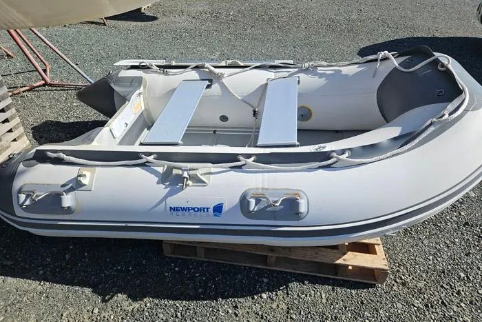  Yacht Photos Pics Inflatable Newport dinghy on wooden pallet, outdoor setting, 2014 Four Winns V375.