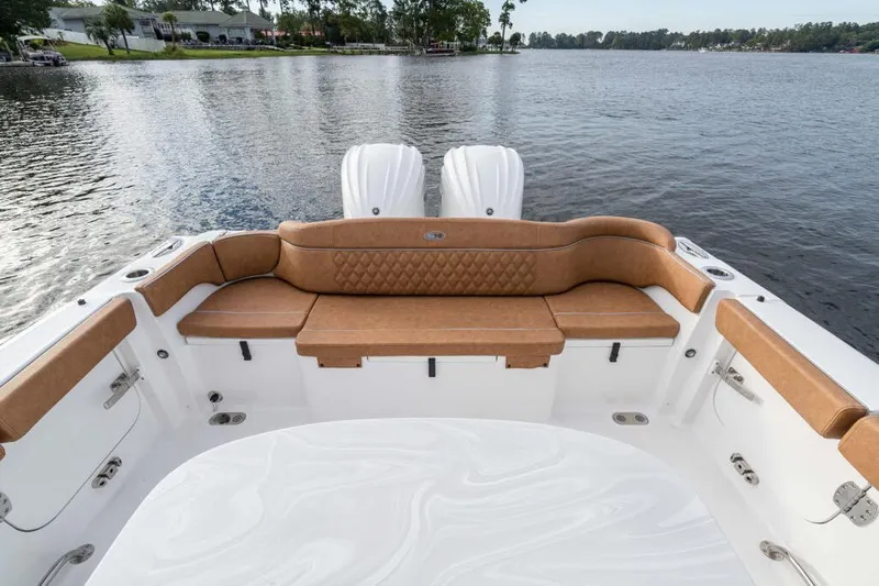  Yacht Photos Pics Manufacturer Provided Image: 2026 Sea Hunt Ultra 285 SE boat interior with tan seating, overlooking serene lake.