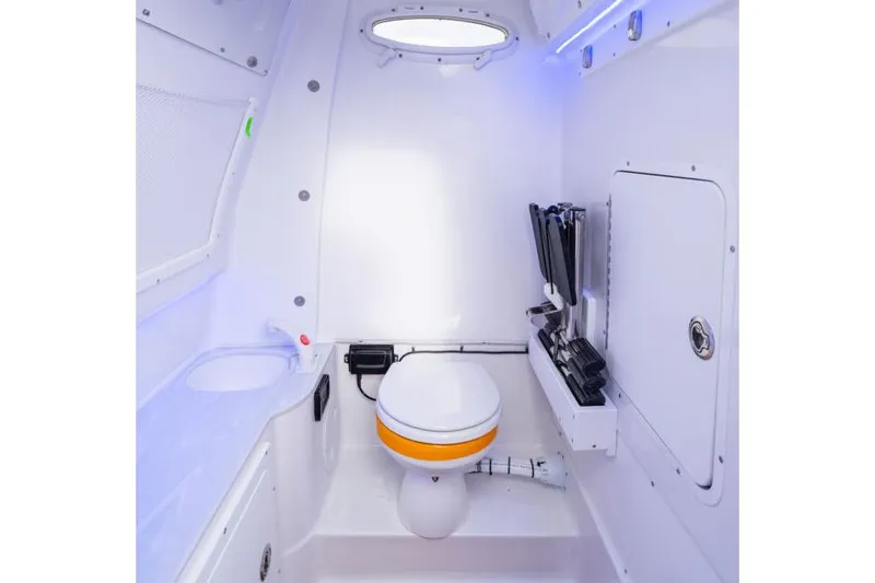  Yacht Photos Pics Manufacturer Provided Image: Interior of 2026 Sea Hunt Ultra 285 SE boat, featuring a compact marine toilet.