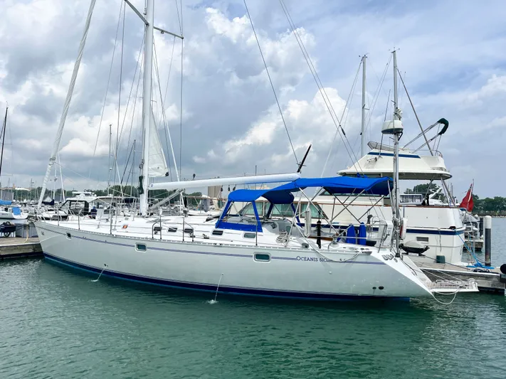 Lali Yacht Photos Pics Sailboat Beneteau Oceanis 510 CU 1994 docked in marina under cloudy sky.