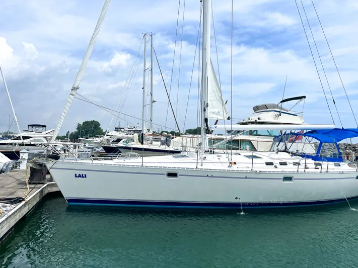 Lali Yacht Photos Pics 1994 Beneteau Oceanis 510 CU sailboat docked at marina under blue sky.