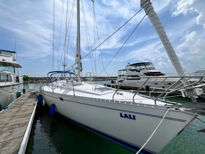 Lali Yacht Photos Pics 1994 Beneteau Oceanis 510 CU sailboat docked at marina under blue sky.