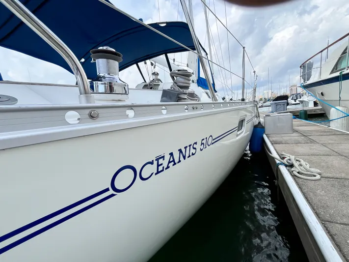 Lali Yacht Photos Pics 1994 Beneteau Oceanis 510 CU yacht docked at marina, showcasing sleek design and branding.