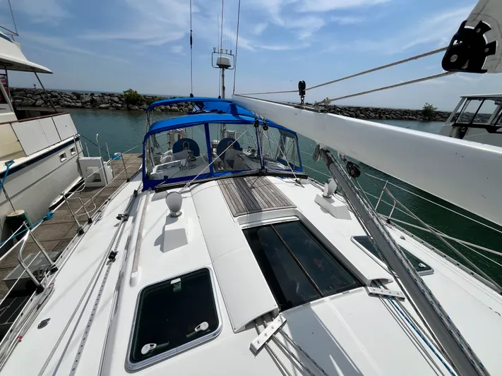 Lali Yacht Photos Pics 1994 Beneteau Oceanis 510 CU sailboat docked, featuring a spacious deck and blue canopy.