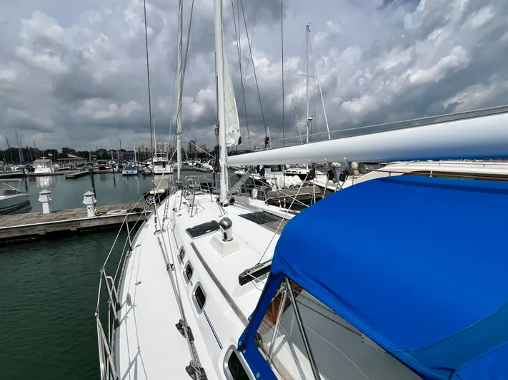 Lali Yacht Photos Pics 1994 Beneteau Oceanis 510 CU sailboat docked at marina under cloudy sky.