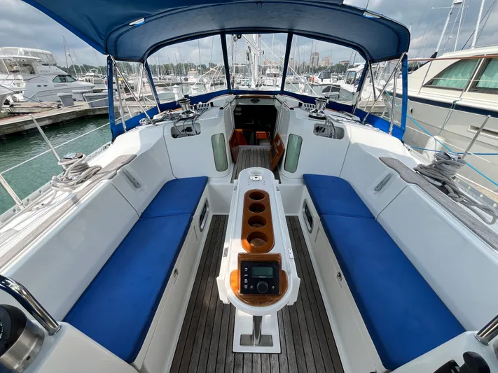 Lali Yacht Photos Pics 1994 Beneteau Oceanis 510 CU yacht cockpit with blue seating and covered helm.