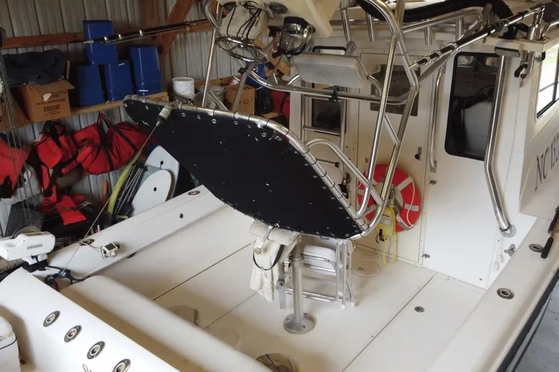  Yacht Photos Pics 2009 McKee Craft 28 boat interior with fishing gear and safety equipment in storage.