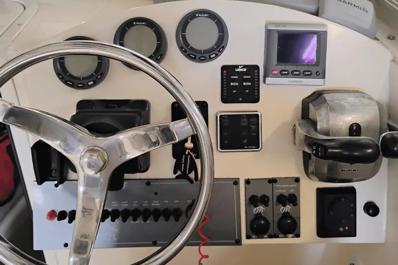  Yacht Photos Pics 2009 McKee Craft 28 boat dashboard with steering wheel, gauges, and controls.